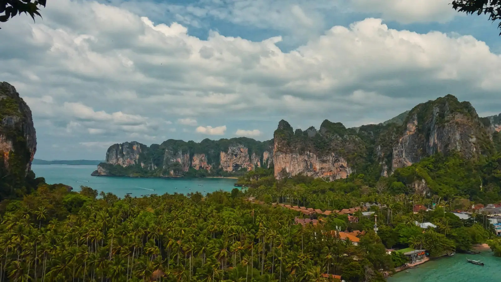 Palm-lined Railay bay beneath the limestone cliffs of Krabi.