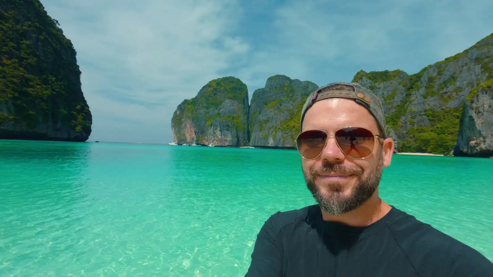 Paradise Adventures creator at Maya Bay, surrounded by limestone cliffs and clear water.